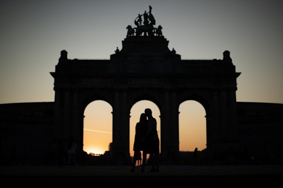 A couple hugs next to the triumphal arch at the Cinquantenaire Park during a partial lockdown to prevent the spread of Covid-19 in Brussels.