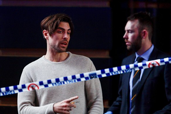 An unidentified man leaves 118 Clarence Street after informing police that he had heard the screams of a woman from inside the apartment building. 