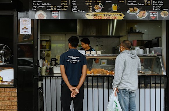 Food vendor Pankaj Sharma serves customers. 