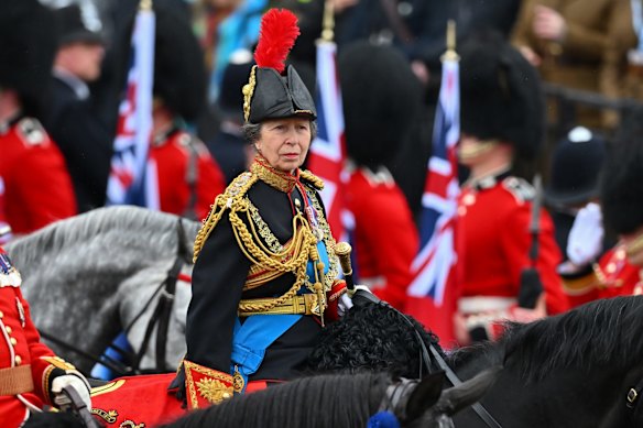 Princess Anne, the Princess Royal, rides behind the coach carrying the newly crowned King and Queen.