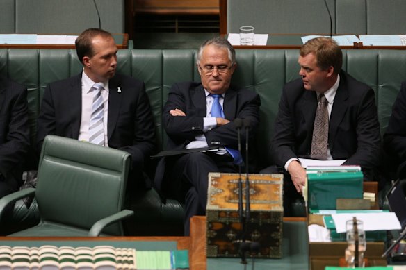 Opposition leader Malcolm Turnbull sits with Peter Dutton and Tony Smith during a division in question time.