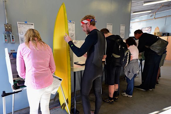 Mike Wigart with his surfboard votes at the Los Angeles County lifeguard headquarters in California