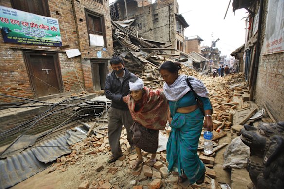 An elderly injured woman is taken to her home after treatment in Bhaktapur near Kathmandu, Nepal, Sunday, April 26, 2015. 