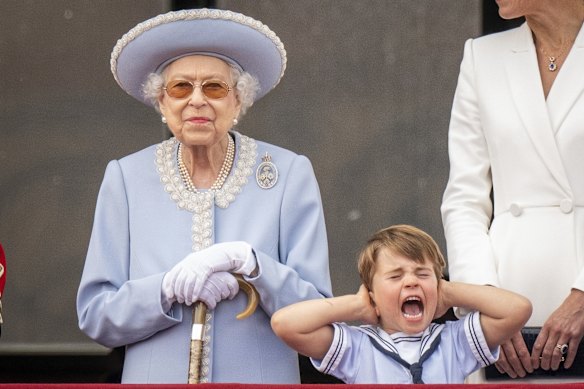 Queen Elizabeth II stands as Prince Louis covers his ears on the balcony of Buckingham Palace after the Trooping the Colour ceremony at Horse Guards Parade.