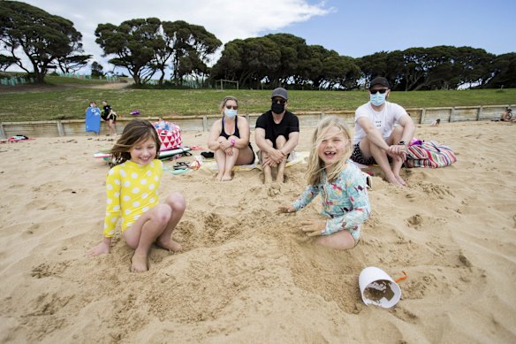 (L) Evie Holzer, 7, and Adele Farrelly, 7 (R) with families at Torquay Foreshore. 