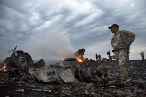 People walk amongst the debris, at the crash site of a passenger plane near the village of Grabovo, Ukraine.