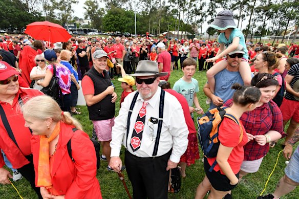 Anti-Adani coal mine protestors are seen rallying at Crosby Park in Brisbane.