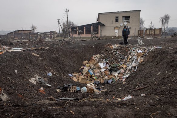A man stands with his dog at the edge of a rocket crater in Boromlya. The town was recently recaptured by Ukrainian forces, according to a statement issued on Sunday by the head of the Sumy regional military administration. Boromlya lies 40km south of Sumy, the regional capital, which has been heavily bombarded by Russian forces.