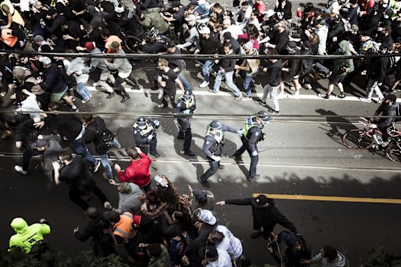Anti-lockdown protestors surround Victoria Police at the rally, which moved from Richmond to Hawthorn.