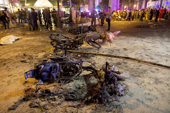 Wreckage of motorcycles are seen as security forces and emergency workers gather at the scene of a blast in central Bangkok August 17, 2015. 