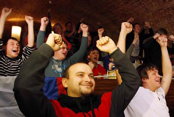 People celebrate at a sports bar in Moscow.