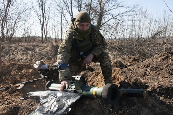 A Ukrainian serviceman guards his position near the outskirts of Kharkiv.