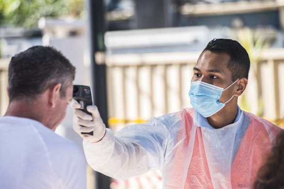 Temperature checks at the entrance of Sydney Fish Markets.
