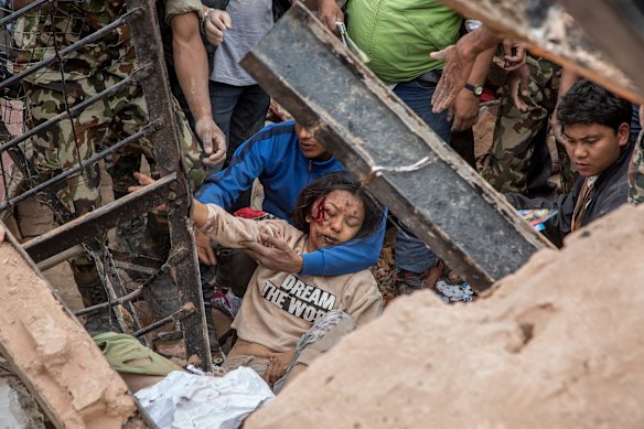  Emergency rescue workers find a survivor in the debris of Dharara tower after it collapsed on April 25, 2015 in Kathmandu, Nepal. 