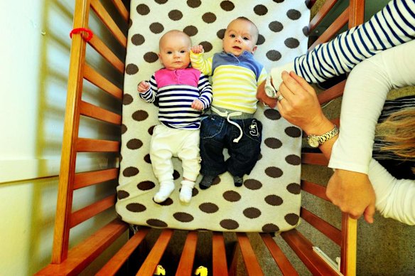 Canberra Capitals coach Carrie Graf, with partner Camille Chicheportische and baby twins Bentley (blue and yellow top) and Charli (blue and pink top).