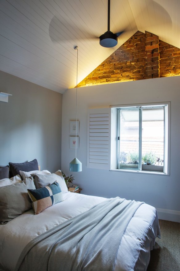 “Our bedroom is very calm and light,” says Alena. “We removed the ceiling, and showing the pitched roof and brickwork makes it feel so much bigger.” 