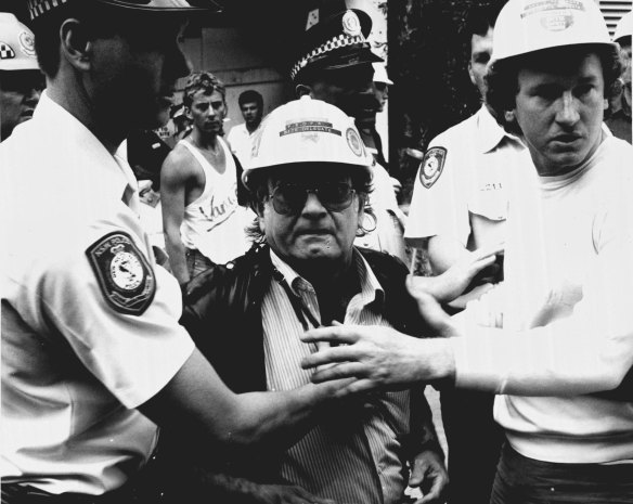 Union delegate held back by police & worker. November 14, 1987.