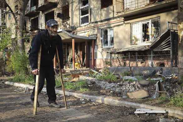 A resident walks past a damaged building in Mariupol that has seen some of the worst devastation since the war began.
