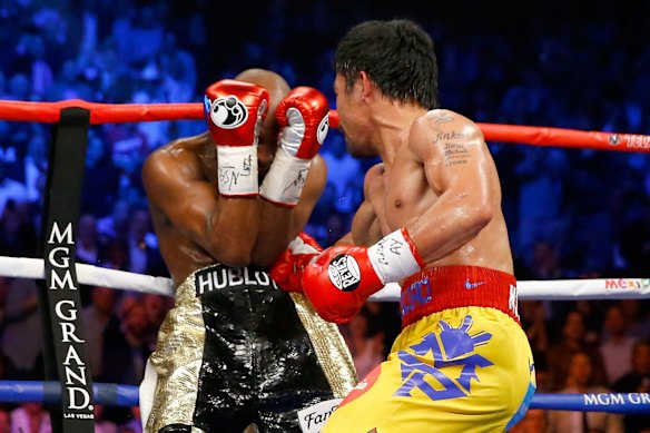 Manny throws a right at Floyd during their welterweight unification championship bout.