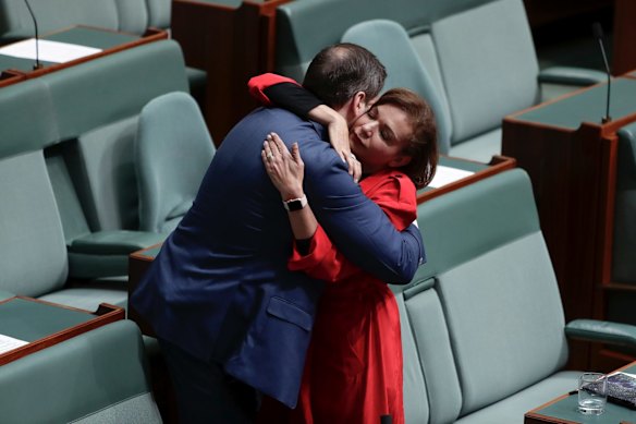 Labor MPs Ed Husic and Anne Aly embrace as the House of Representatives condemns Senator Fraser Anning's first speech.