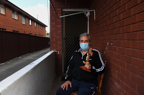 Kamil Polus who has had one COVID-19 vaccine shot sits in-front of his apartment holding a religious cross in Fairfield. Kamil is looking forward to returning to church when the COVID-19 lockdown ends.