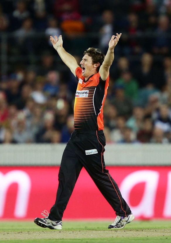 Brad Hogg of the Scorchers celebrates taking the wicket of Jordan Silk of the Sixers.