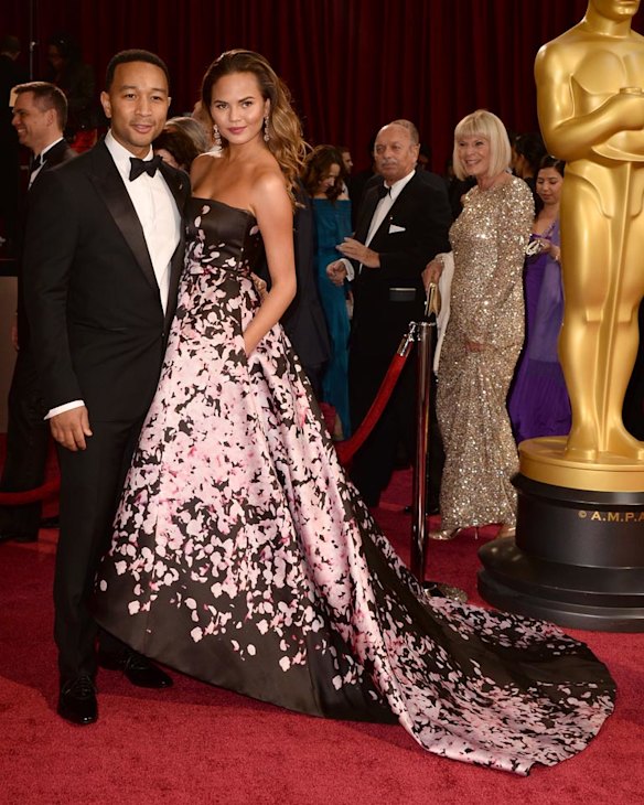 HOLLYWOOD, CA - MARCH 02:  Singer John Legend (L) and model Christine Teigen attend the Oscars held at Hollywood & Highland Center on March 2, 2014 in Hollywood, California.  (Photo by Frazer Harrison/Getty Images)
