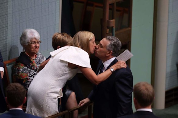 Treasurer Joe Hockey is embraced by his wife Melissa after he delivered his first budge.