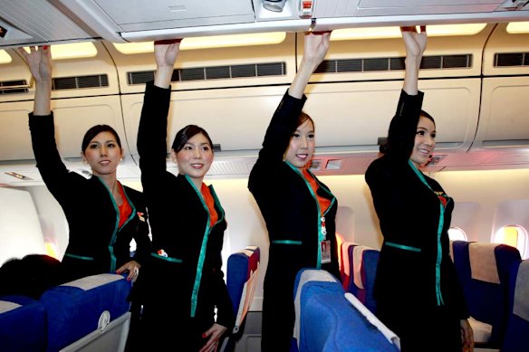 Thai transsexuals flight attendants, from left to right, Chayathisa Nakmai, Nathatai Sukkaset, Phuntakarn Sringern and Dissanai Chitpraphachin pose inside a PC Air plane. 