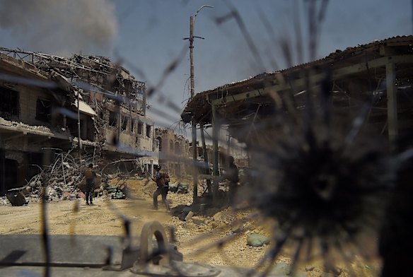 Iraqi soldiers at a firing position in West Mosul, on street where six IED's are yet to be cleared.