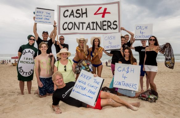 Queensland's environmental campigner Toby Hutcheon - lying on the beach - begins his campaign to recycle plastic containers from Queensland beaches.