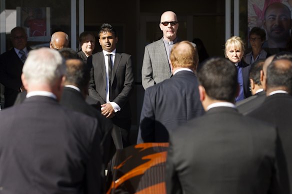 Myruan Sukumaran's brother Chinthu awaits his brothers coffin at the entrance to the church. 