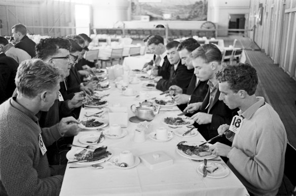 The recruits sit down to a meal.