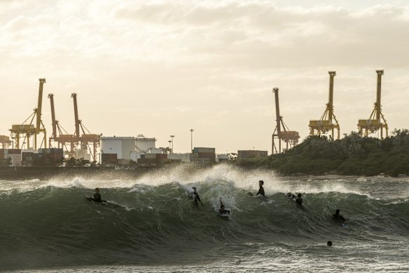 Young surfers brave rare waves breaking inside Botany Bay as damaging southerly winds hit Sydney.