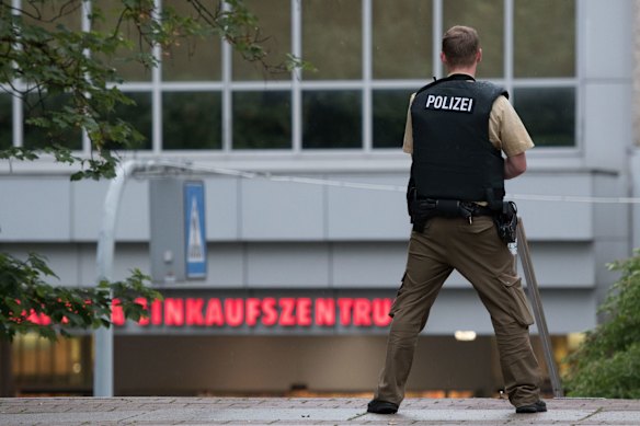 A police officer stands outside the Olympia mall.