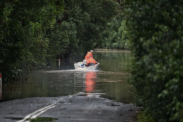 Police and SES near the scene of where a man's body was found in a car washed away in floodwaters on Cut Hill Rd in Cobbity.