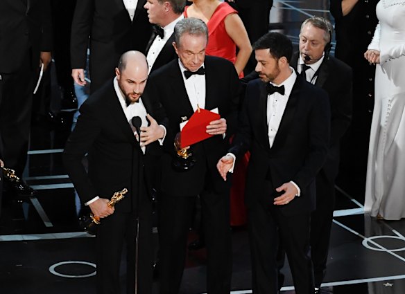<i>La La Land<i> producer Jordan Horowitz, left, announces the actual best picture winner as <i>Moonlight</i> after a presentation error with actor Warren Beatty, centre, onstage.