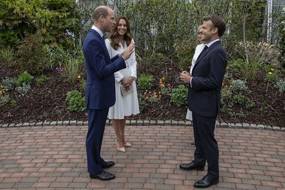 Britain's Prince William and Kate, the Duchess of Cambridge speak to French President Emmanuel Macron and wife Brigitte, at a reception for the G7 leaders at the Eden Project in Cornwall, England, Friday June 11, 2021, during the G7 summit.