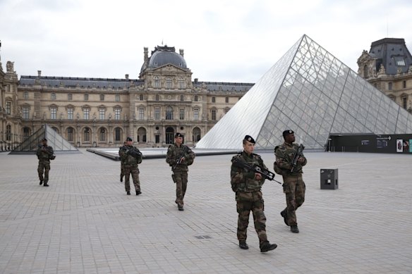 French military patrol the Louvre in Paris France which reopened.