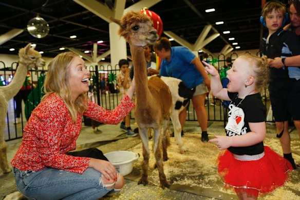 Channel Nine's Airlie Walsh with three-year-old Evah Randell at the Variety Xmas Kids Party.