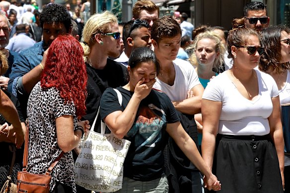  A Lindt Cafe worker grieving in Martin Place on Tuesday, as hundreds arrived to lay flowers. 