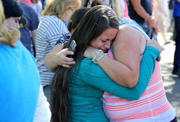 A woman is comforted after the shooting at Umpqua Community College.
