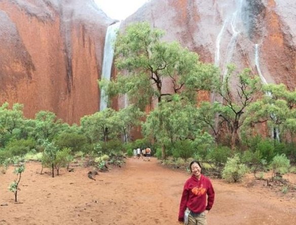 Tourist celebrates Uluru waterfalls 