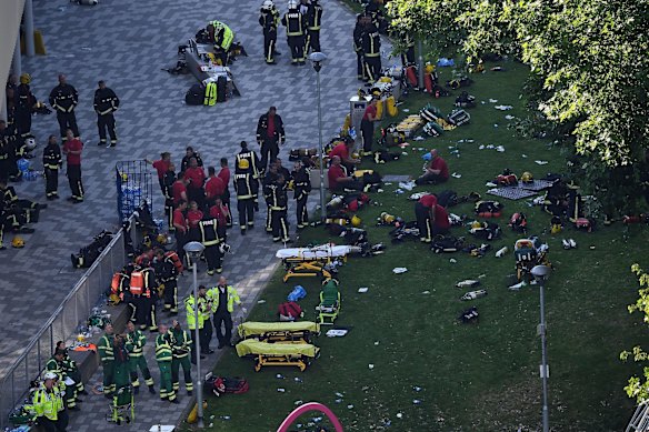 Fire fighters and emergency services gather at the building after the huge fire.