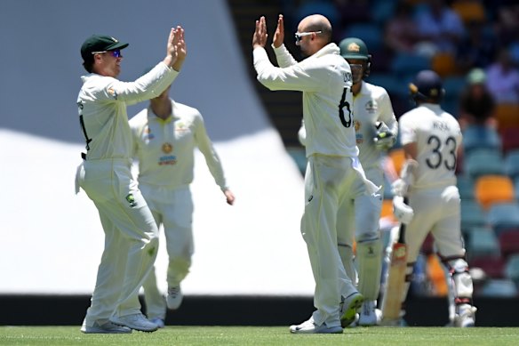 Nathan Lyon of Australia celebrates taking the wicket of Mark Wood of England for 6 runs during day four of the First Test Match in the Ashes series between Australia and England at The Gabba on December 11, 2021 in Brisbane, Australia. 
