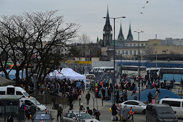 People gather outside the Lviv railway station where trains and buses leave for Poland. According to the United Nations, more than half a million people have fled Ukraine since the beginning of the Russian invasion.