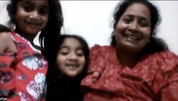 A tearful Priya Murugappan celebrates with daughters Kopi and Tharni on hearing the news that they can return to Biloela.