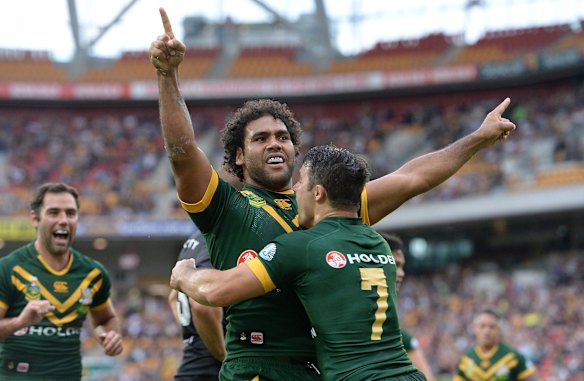 Sam Thaiday of Australia celebrates a try with Cooper Cronk. 