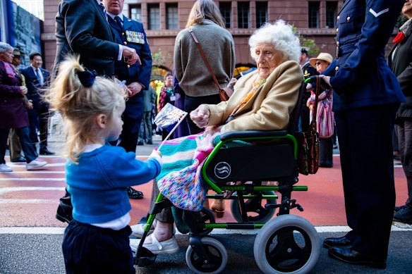 War widow Margaret Ferrier with Imogen Steyn, 4, before ANZAC Day march down Elizabeth St, Sydney.