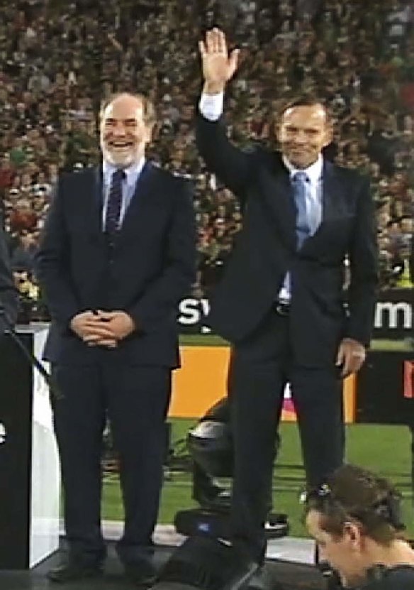 Tony Abbott acknowledges the boos from the crowd at the 2014 NRL grand final.
